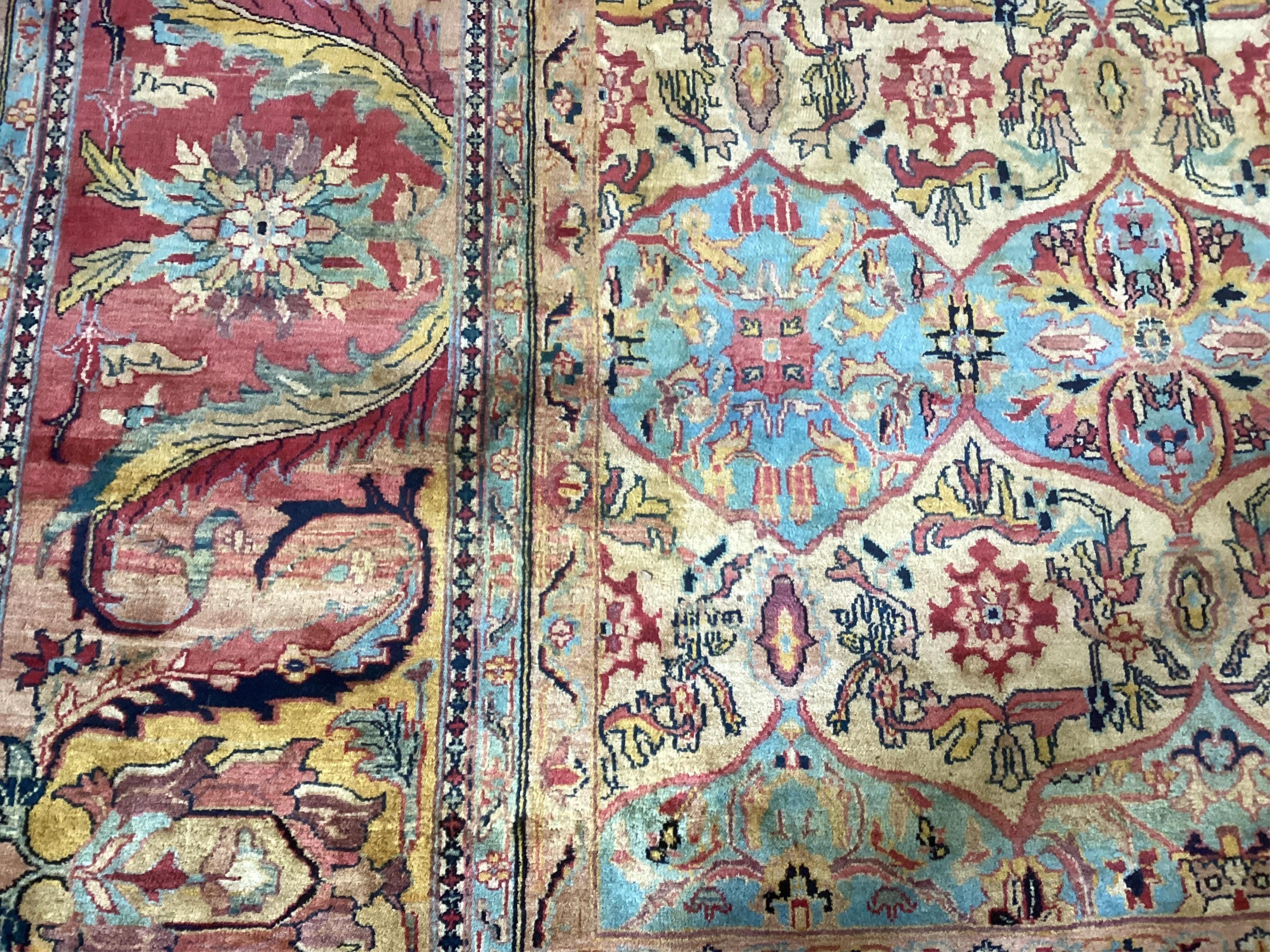 A large Persian design ivory ground carpet, 590 x 365cm. Condition - good